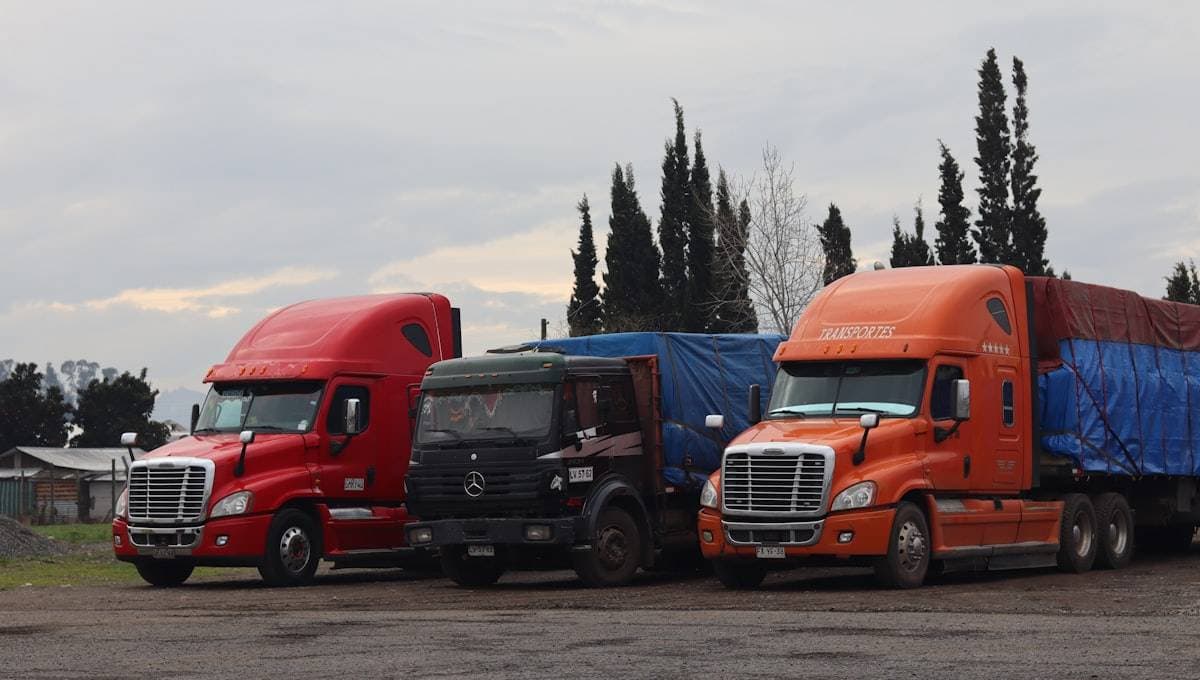 Fleet of trucks and commercial vehicles at a transport depot. MapTrack tracks vehicles, trailers and mobile assets for Australian fleet operators