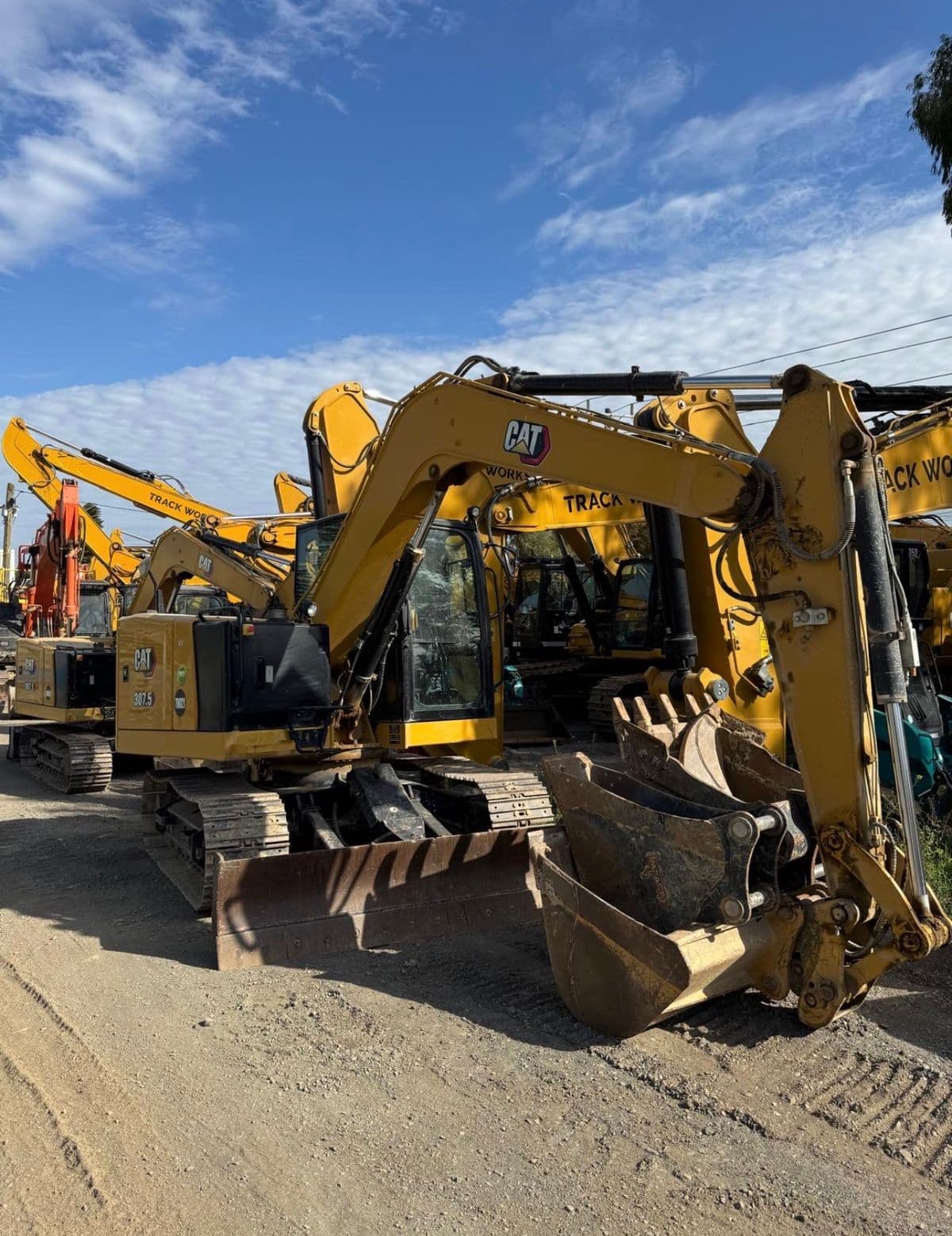 CAT excavators lined up in a customer equipment yard