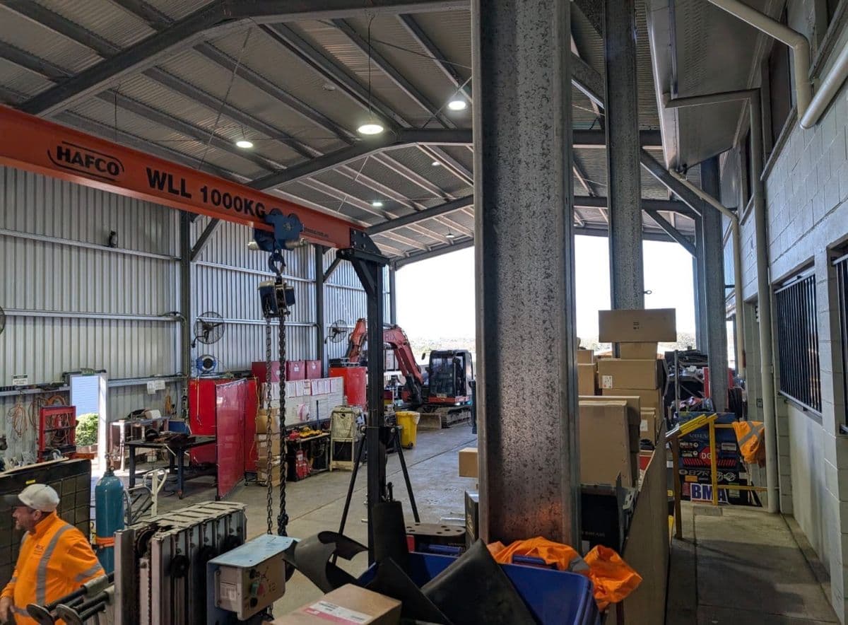 Customer workshop with overhead crane and excavator