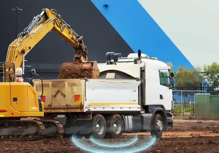 Illustrative site: an excavator loading soil into a white rigid tipper truck beside a warehouse, with a MapTrack Vehicle Service card counting down the kilometres to the next service laid beside it.
